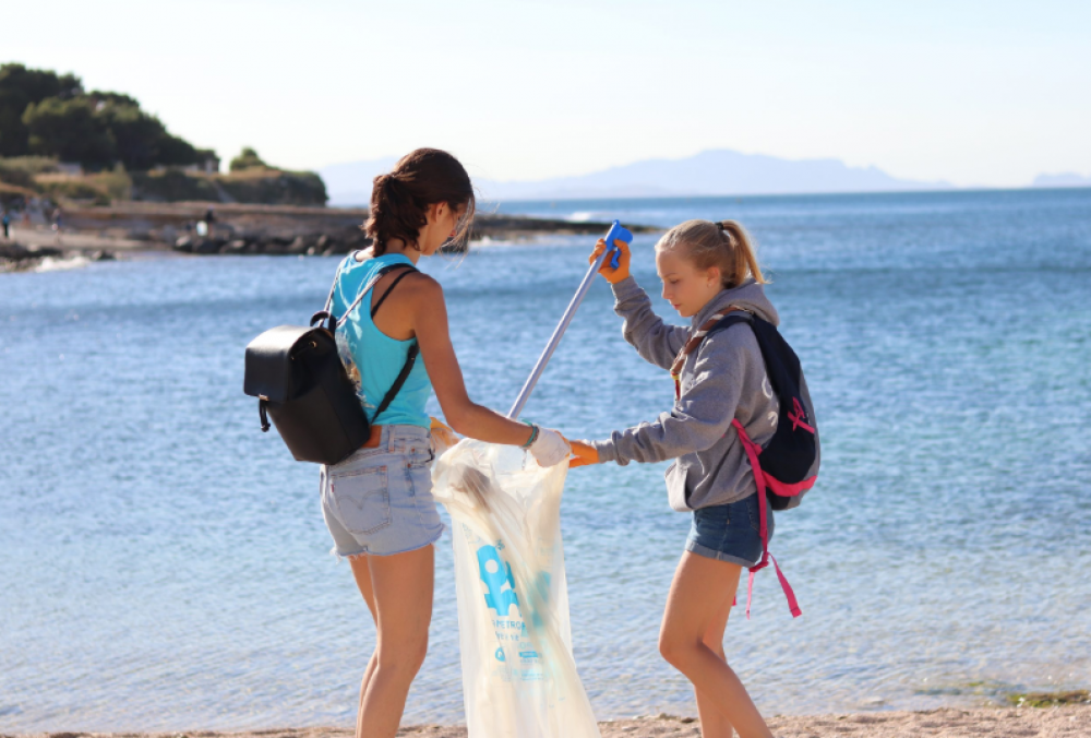 2 personnes ramassant des déchets à la plage